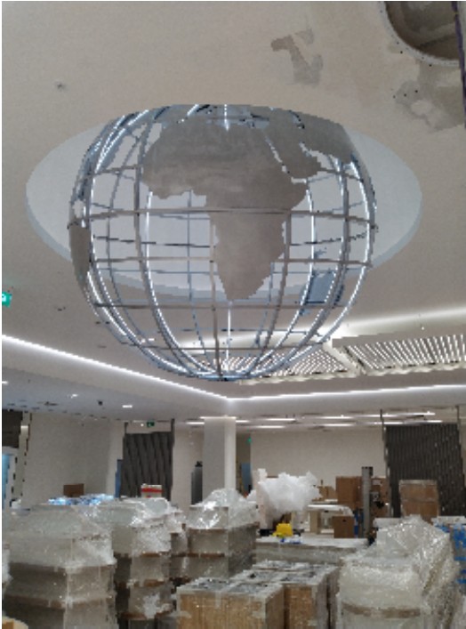 Planet Beauty globe being installed on site with LED strip lighting