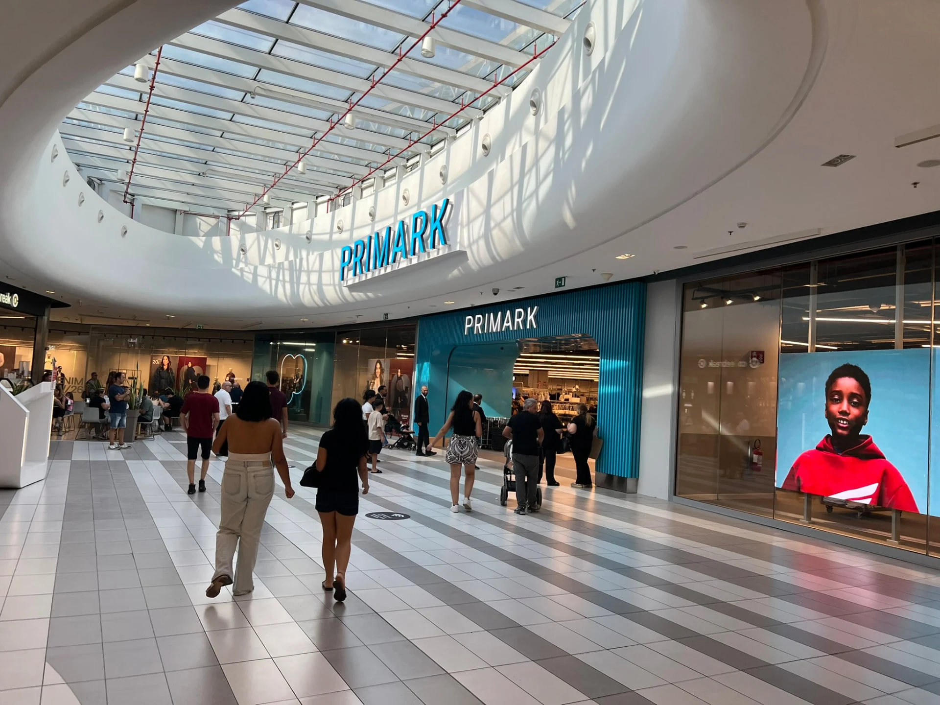 Wide view of the Primark Pompeii shopfront beneath the shopping centre skylight