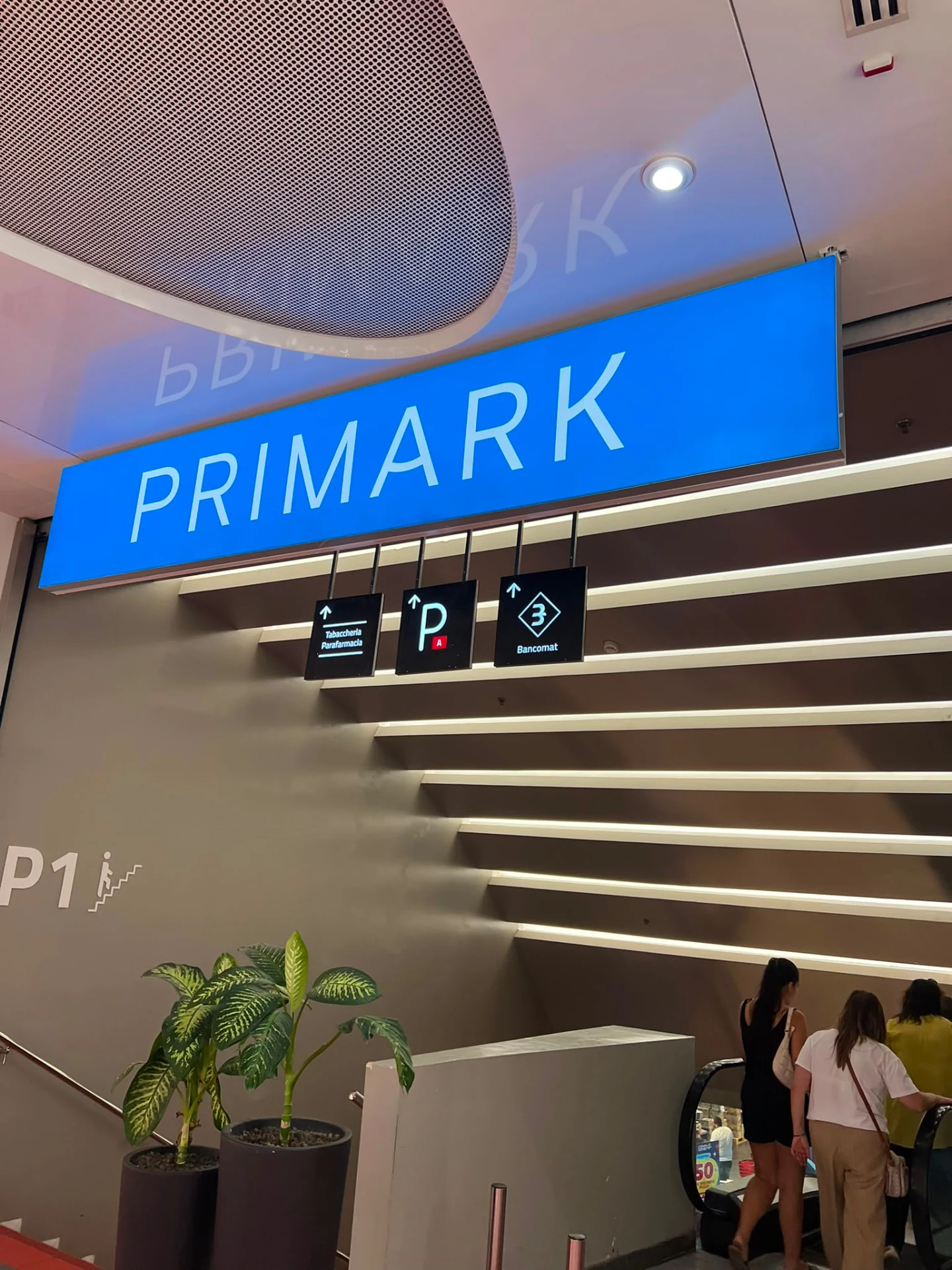 Suspended Primark sign above the shopping centre escalator