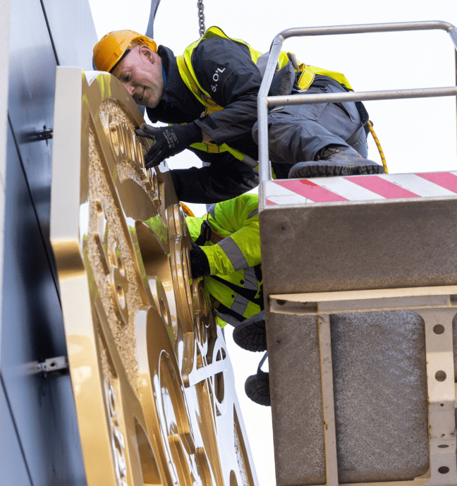 Maintenance worker working on a sign